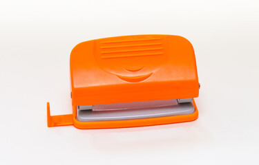 Orange and gray hole punch on a white background