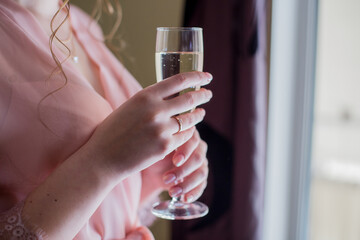 woman in peignoir with a glass of champagne