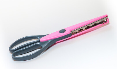 pink and gray fancy scissors to trim the edges of photos