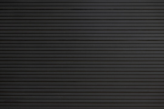 black steel wall background and texture. black metal shutter door.