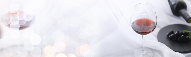 Glass with grape red semi-dry wine. Valentine's day concept background. Gift for the holiday. Sweet sparkling wine.