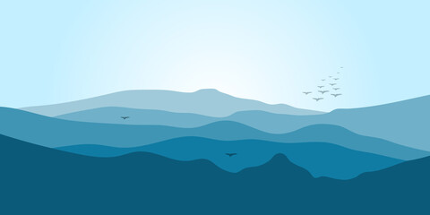 Fototapeta na wymiar Mountain landscape in blue tones with fog and flying birds.