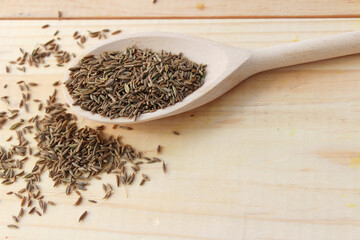 spice cumin in a wooden spoon