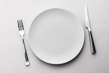 Empty plate and cutlery as mockup set on white background, top tableware for chef table decor and...