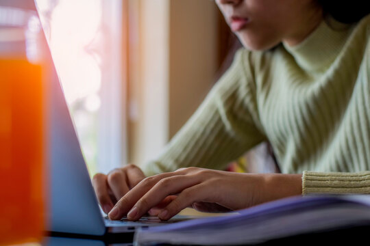 Young asian woman or female student work on laptop computer at workplace. Online working, work from home concept.