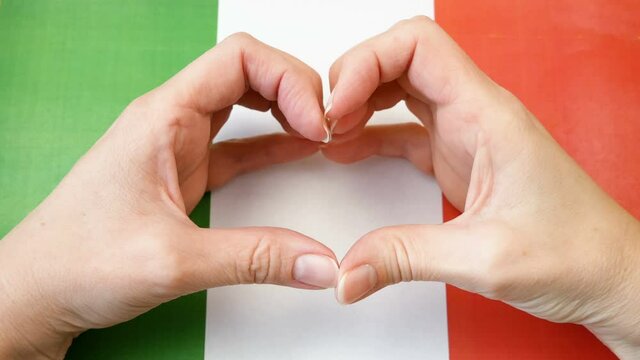 I love Italy. Hands make heart on Italian flag background. Festa della Repubblica, 2 june, italy day
