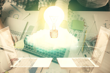 Double exposure of man and woman working together and bulb drawing. Computer background. Top View. Idea concept.