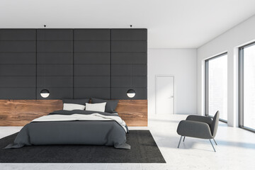 Grey tile and white bedroom with armchair