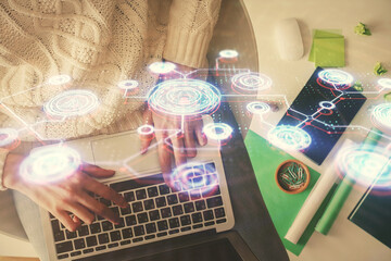 Double exposure of woman hands working on computer and social network theme hologram drawing. Top View. People connection concept.