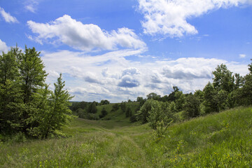 Spring hills on a background of clouds
