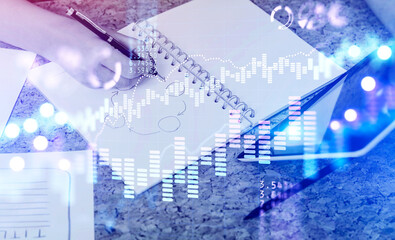 Woman hand writing, financial chart
