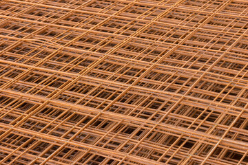 Steel bars used for reinforced concrete stacked in layers. Closeup of  steel rebars pile. Wire mesh steel for construction and building work.