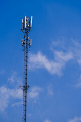 Telecommunication telephone signal transmission tower with beautiful blue sky and cloudy background