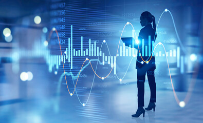 Woman trader with laptop in office, forex graph