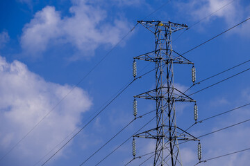 Electrical tower station wiring power with cloudy and blue sky background, High voltage station post