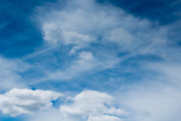 Blue sky with white cirrus clouds and cirrocumulus clouds and  cumulonimbus clouds. Beautiful cloudy sky background. Concept of sky, summer, freedom, heaven, clouds, white, blue...