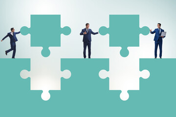 Businessman in teamwork concept with jigsaw puzzle