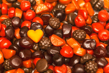 Gummy in heart shape on top of vitamins