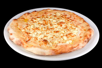 Tasty flat small bread with feta cheese and yellow cheese on a plate, isolated on black background.