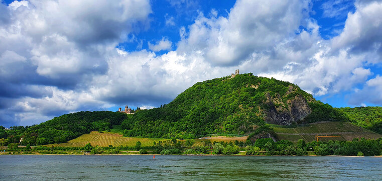 Bonn Mehlem Germany at the beginning of may in the evening on the Rhine with view of the Rhine, sevenhills, Drachenfels/Dragonrock and castle Drachenburg with blue sky and white clouds
