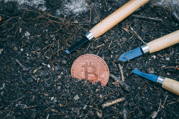 Bitcoin on dirty ground, business or technology concept