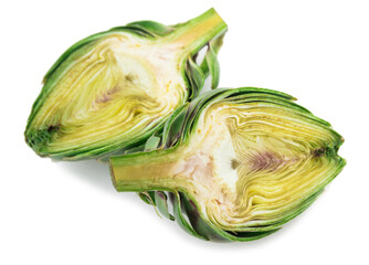 two halves of ripe green artichokes on a white background