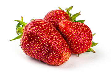 three whole ripe red strawberries on the white background