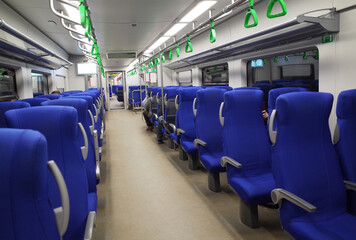 Blue seats in a high-speed train car.