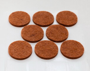 Eight slices of brown cloth on a white background