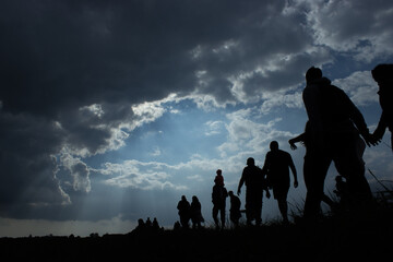 Immigration of people blue sky with dark clouds - obrazy, fototapety, plakaty