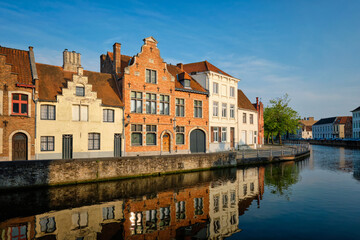 Fototapeta na wymiar Typical Belgian cityscape Europe tourism concept - canal and old houses on sunset. Bruges (Brugge), Belgium