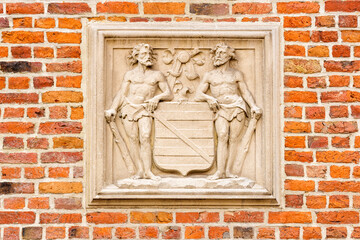 coat of arms on a brick house in Bruges, Belgium
