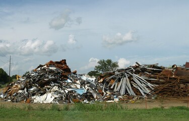 Huge pile of scrap metal and assorted junk by the roadside