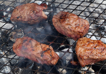 Barbecue cooking in an urban house garden in summer weather. UK.