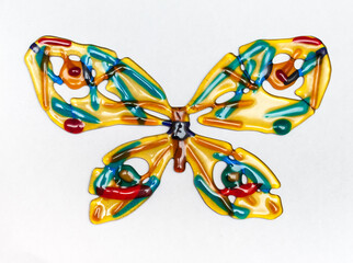 Butterfly made of colored glass on a white background closeup