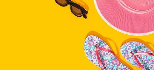 Banner Flat lay composition with summer vacation accessories on yellow background. Summer background top view. Copy space