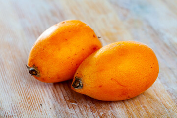 Ripe medlar fruits nispero on wooden surface