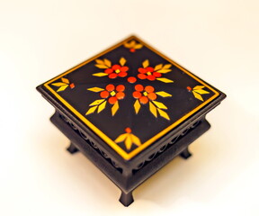 Purchased black painted box closeup on white background