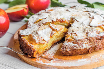 Apple pie on a white wooden table