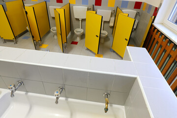 nursery bathroom with yellow doors and white ceramic sink