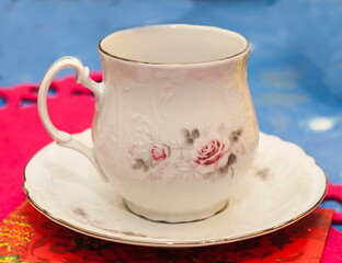 Cup saucer for drinks on color napkin, on the table