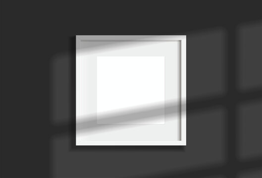 Minimal empty square white frame picture mock up hanging on dark wall background with window light and shadow. isolate vector illustration.