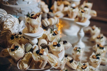 Delicious dessert table with cupcakes at reception closeup.