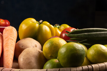 vegetables on a wooden table with black background