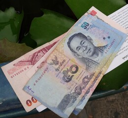 BANGKOK, THAILAND—MARCH 2016: Thailand currency bills, 50 and 100 baht bills on a table