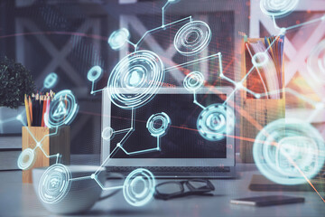 Computer on desktop with social network hologram. Multi exposure. Concept of international people connections.