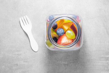 Packed fruit salad in glasses jar. Healthy meal to go