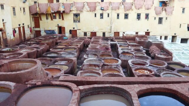 Vats of a tannery workshops in Fez close up. Famous leather factory of Morocco. Vats with paint. Old tanks at leather tanneries with color paint.