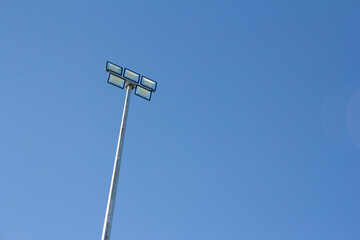 Spotlight in stadium against blue sky. Sports field lighting in the evening