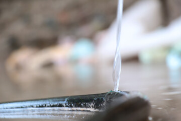 Obraz na płótnie Canvas Torn hose is leaking water, be economical